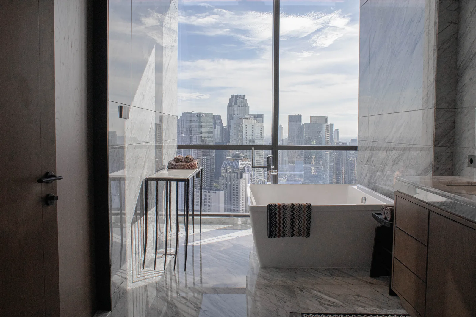 Regent Residences Jakarta 3 Bedroom bathroom with freestanding bathtub and Jakarta skyline view